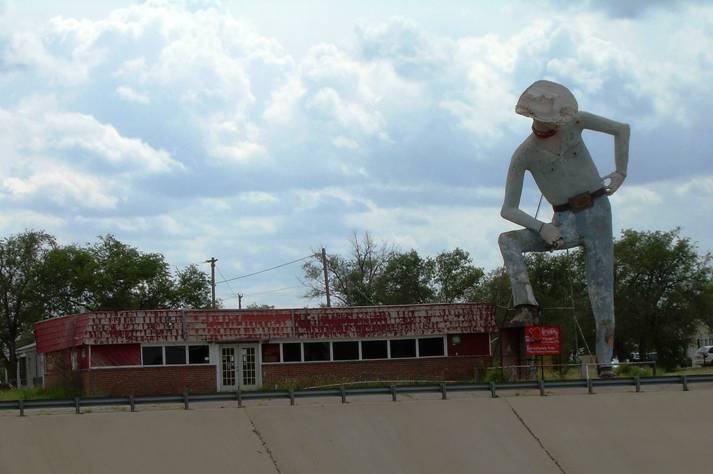 Old Roadhouse in Amarillo Texas. The new highway ( I-40)is in front in the culvert with Rt 66 behind - running alongside. This cowboy is just waiting to fall down! We wouldn't allow this in Australia I think!